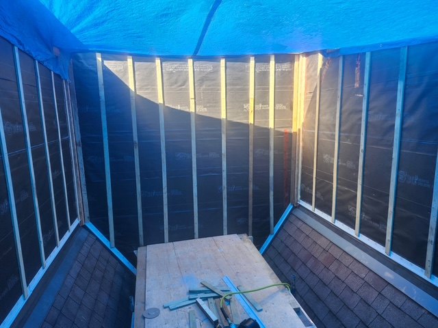 Exterior siding installation with rain screen in progress